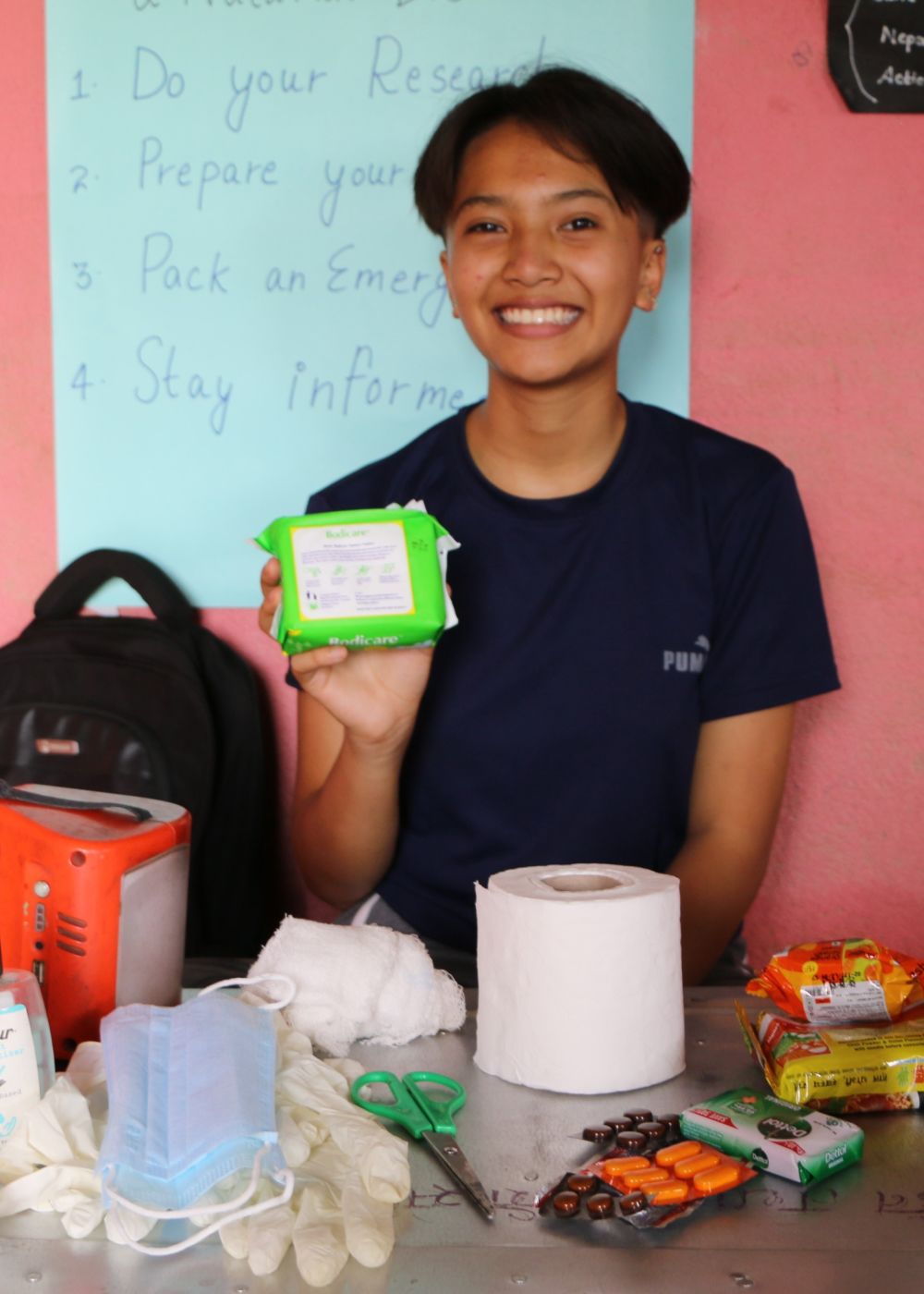 Purnika packing an Emergency Go-Bag with essential items – she is part of a collection of youth volunteers who are leading the way to help keep people safe during emergencies. Angela Shrestha/ActionAid