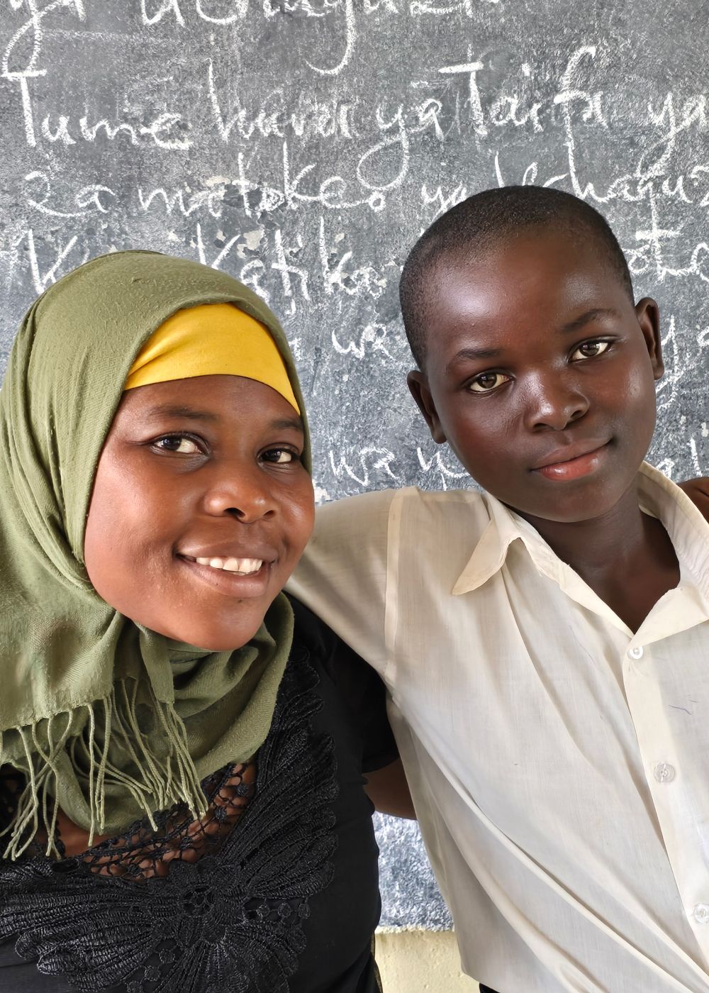 12-year-old Zawadi (pictured here with her teacher) is an environment champion and is part of a school club that has planted over 200 trees. Ramadhan Kawanga/ActionAid