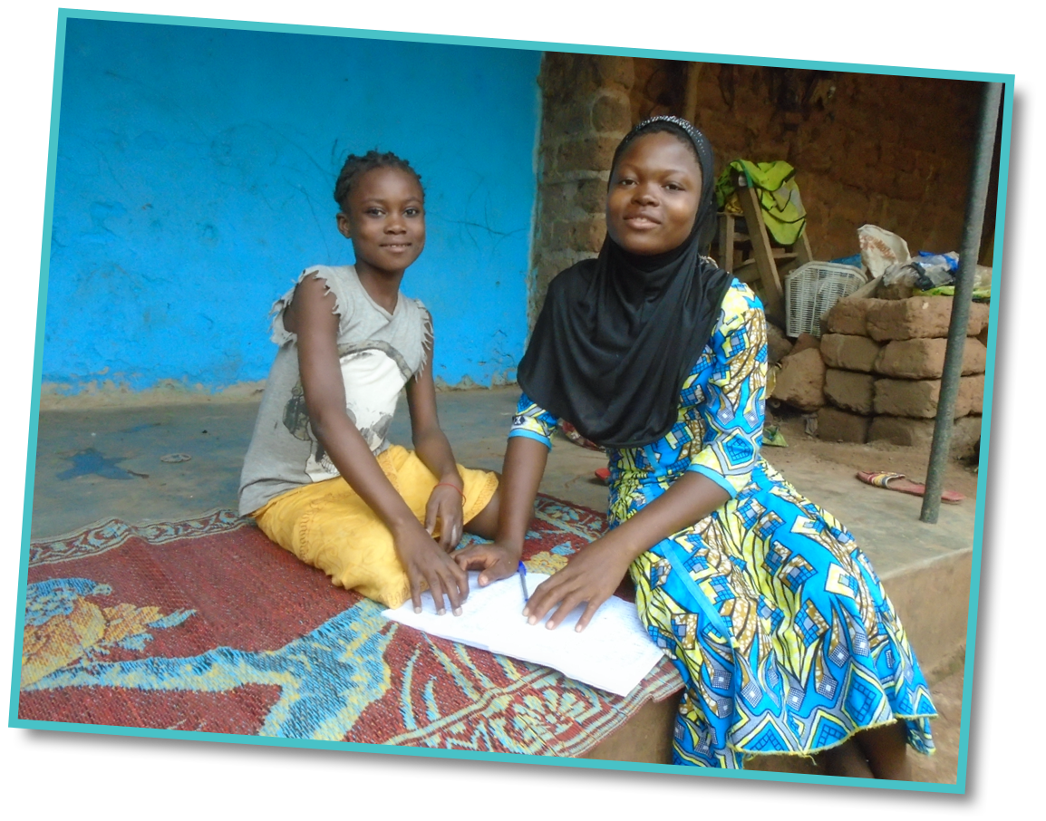 Alimanta (right) enjoys going to school now the facilities have been improved